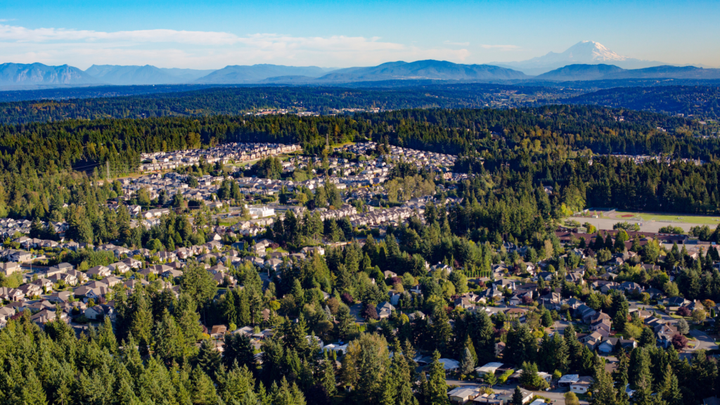 An aerial shot over Bothell looking towards the Cascade Mountains and Mt Rainier