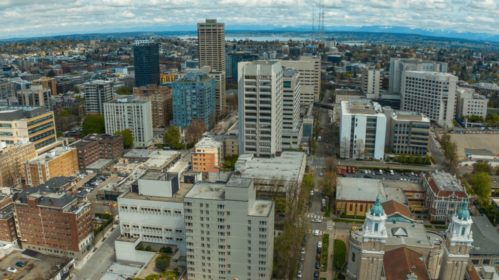 An elevated shot looking over Seattle's Capitol Hill neighborhood, facing east toward Bellevue and the Cascade Mountains