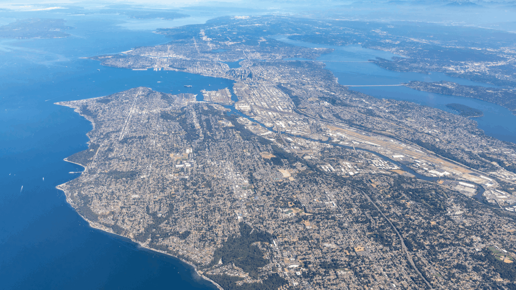 A high altitude aerial shot overlooking Seattle and Lake Washington with parts of the east side of King County visible