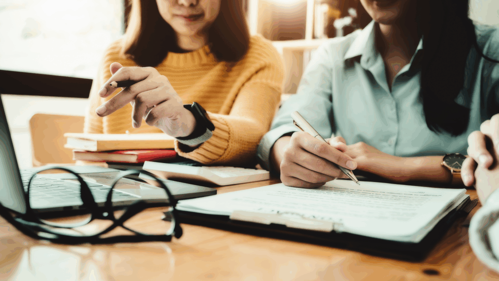 Two employees focused on paperwork
