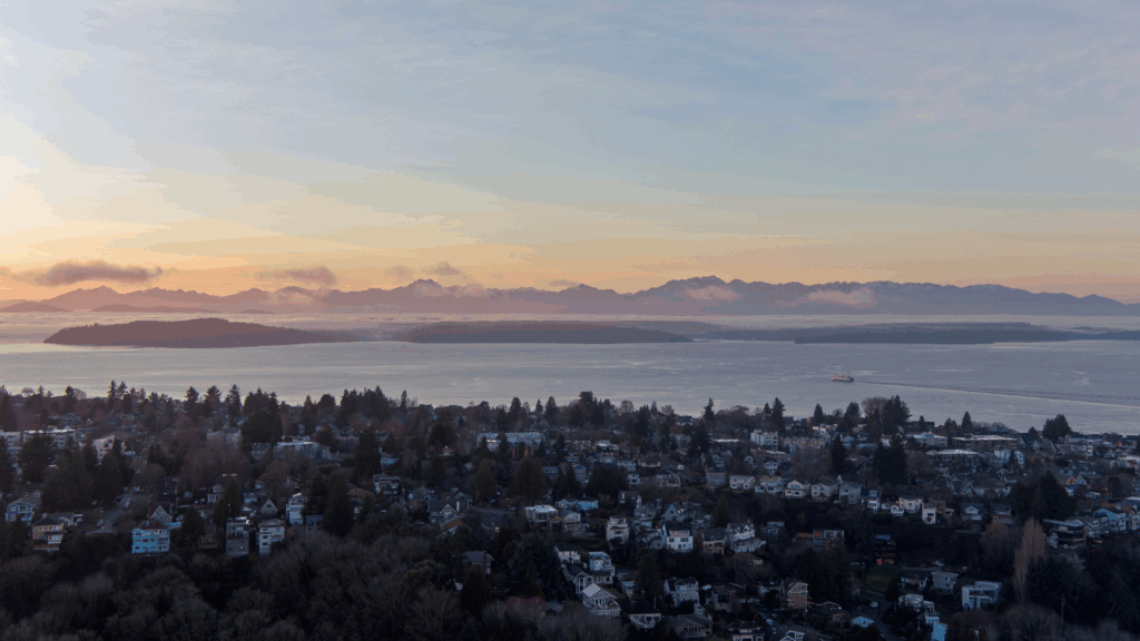 An aerial shot overlooking West Seattle looking over the Puget Sound and toward the Olympic Mountains