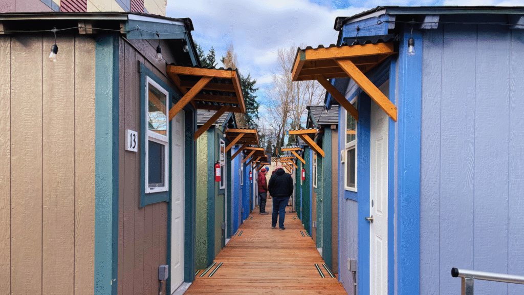 A photo looking down the row of ADA accessible houses at Olympic Hills Tiny House Village during the grand opening event on February 19