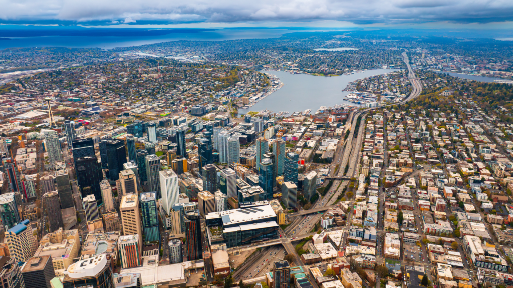A high-altitude shot overlooking several Seattle neighborhoods and Lake Union.